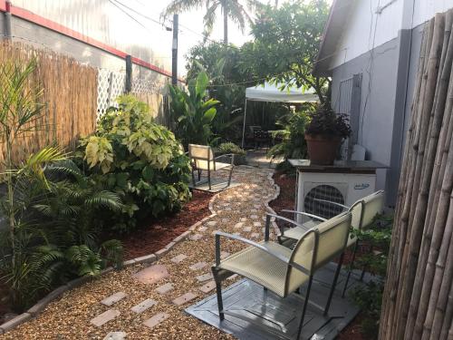 a patio with two chairs and a fire place at INN LEATHER GUEST HOUSE-GAY MALE ONLY in Fort Lauderdale