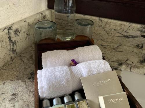 a wooden box with towels and bottles on a counter at Las Cruces Boutique Hotel in Antigua Guatemala