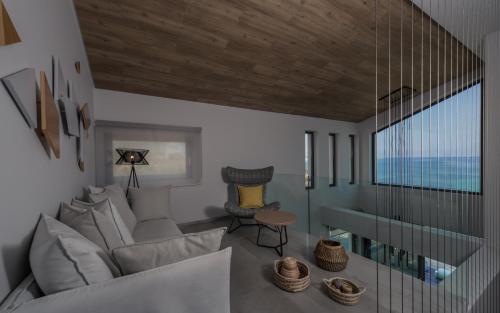 a living room with a couch and a table at Sueño LUXURY VILLA, in Argasi 180 Iconic Sea View in Argasi