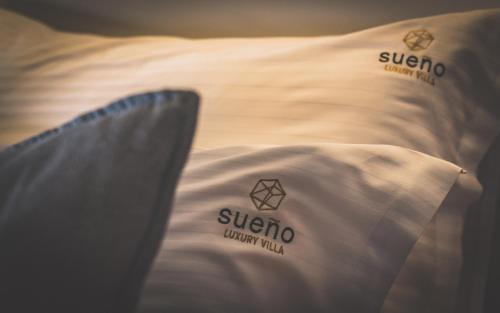 a close up of a pillow on a bed at Sueño LUXURY VILLA, in Argasi 180 Iconic Sea View in Argasi
