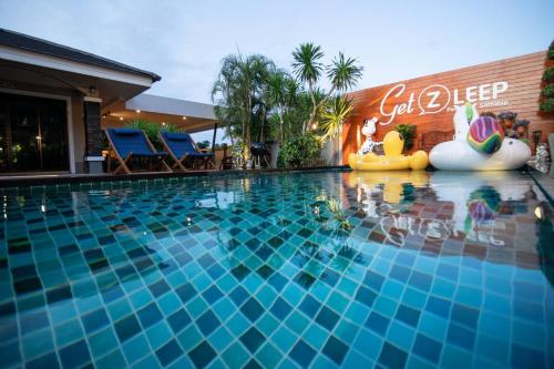 a pool at a hotel with an inflatable pool toy at GetZleep House Sattahip in Sattahip