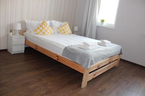 シュチェチンにあるSMM Apartament Stettinのベッドルーム1室(大型ベッド1台、黄色と白の枕付)