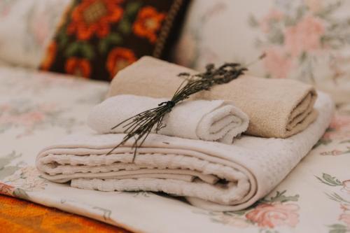 a pile of towels sitting on top of a table at Art Gallery Residence in Braşov
