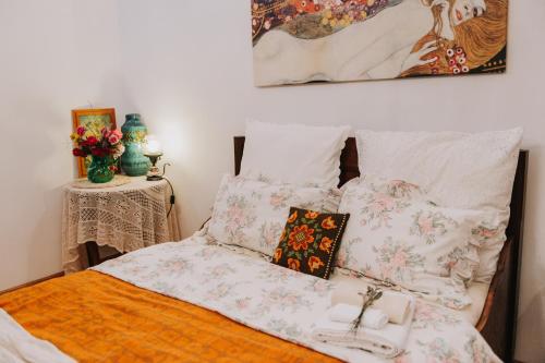 a bed with a bunch of pillows on it at Art Gallery Residence in Braşov