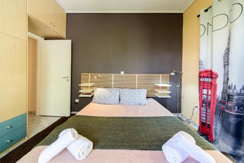 a bedroom with a bed with a red telephone booth at warm cozy & quiet in Athens