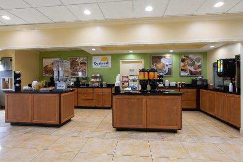 a waiting room with a coffee shop with a cash register at Days Inn by Wyndham Absecon Atlantic City Area in Absecon