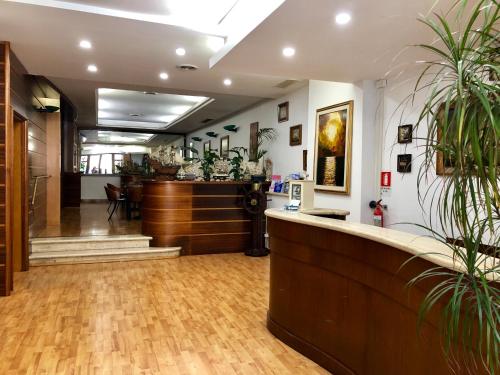 a lobby of a salon with a reception desk at Hotel La Bussola in Anzio