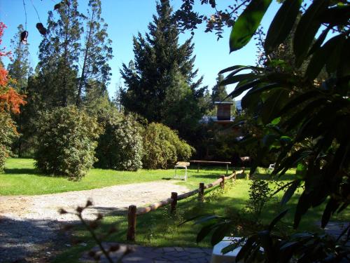 a park with a wooden fence and a goal at Cabañas Auquin Lemu in Lago Puelo