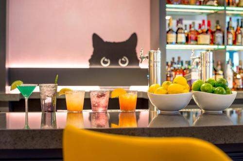 a bar with drinks and bowls of fruit on a counter at Warwick Denver in Denver