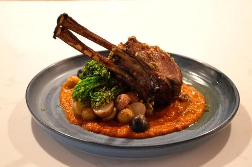 a plate of food with a piece of meat and vegetables at Warwick Denver in Denver