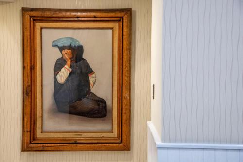 a picture of a painting of a woman with an umbrella at Suites Coben Apartamentos Amueblados in Mexico City