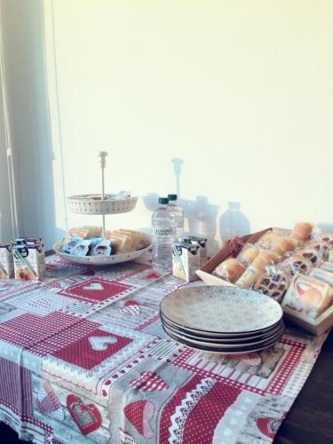 a table with a table cloth with plates and pastries at Villa Sofia in Pramaggiore