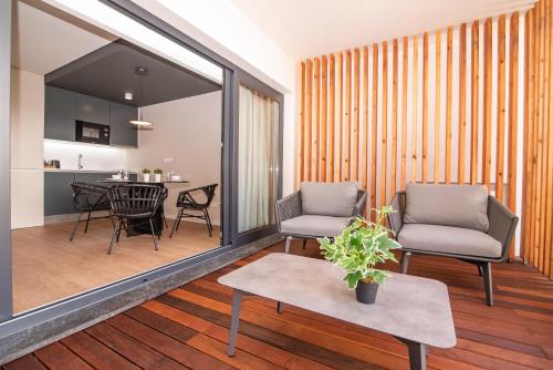 a living room with two chairs and a table at Villa Esmeralda in Ponta Delgada