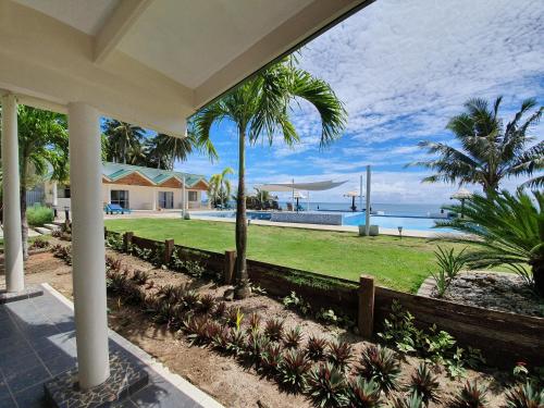 a porch of a house with a view of the ocean at Le Uaina Beach Resort in Falepuna