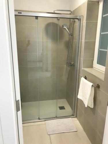 a shower with a glass door in a bathroom at Teleworking Silent new and modern in Los Realejos
