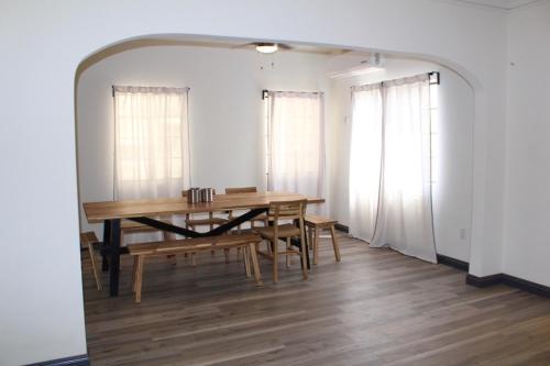 a dining room with a wooden table and chairs at 8th and Ardmore in Los Angeles