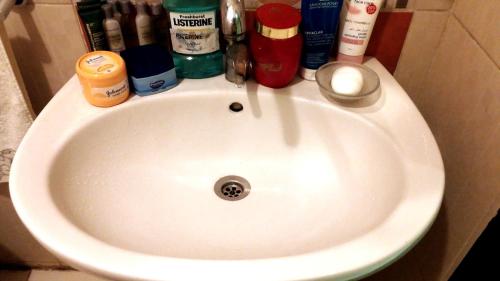 a white sink in a bathroom with toiletries on it at Private Room In Apartment with Sea & Hilton View in Alexandria