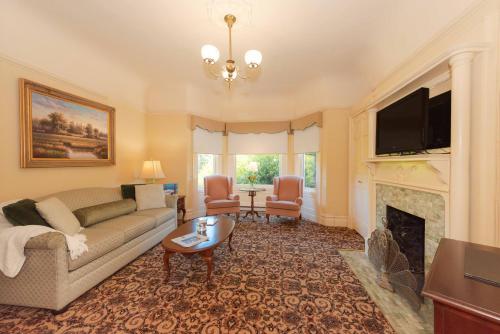 a living room with a couch and a fireplace at Stanyan Park Hotel in San Francisco