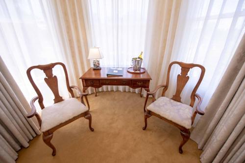 a room with two chairs and a table with a lamp at Stanyan Park Hotel in San Francisco