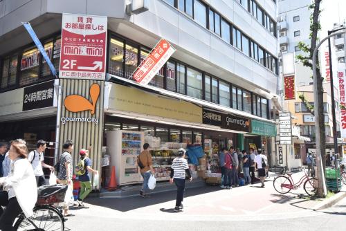 a group of people standing outside of a building at Enzo Shin-Osaka C in Osaka