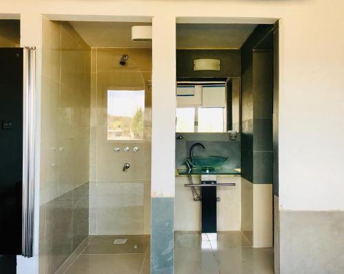 a bathroom with a sink and a shower at Alondra Boutique in Villa Cura Brochero