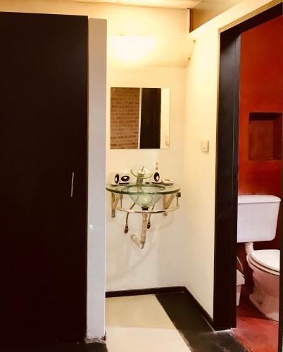 a bathroom with a sink and a toilet at Alondra Apart in Villa Cura Brochero