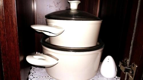 a stack of white coffee pots sitting on a table at Private Room In Apartment with Sea & Hilton View in Alexandria