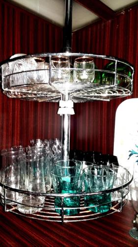 a glass tray with glasses on top of a table at Private Room In Apartment with Sea & Hilton View in Alexandria