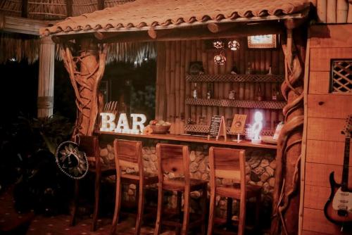 a bar in a play house with chairs at Casa de Olas Boutique Hotel in Puerto Escondido