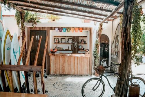 a bike parked in a room with surfboards at Casa de Olas Boutique Hotel in Puerto Escondido