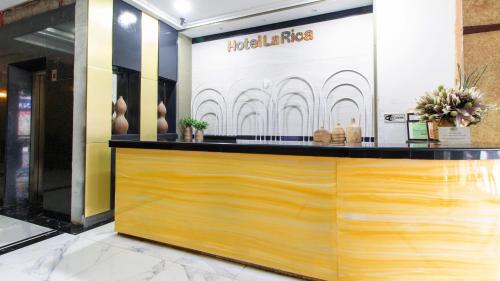 a store front with a wooden counter in a lobby at RedDoorz @ Downtown Tacloban in Tacloban