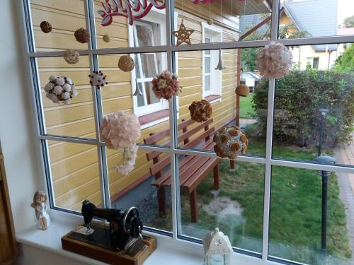 a window with a view of a bench in a yard at Vila Liepa in Birštonas