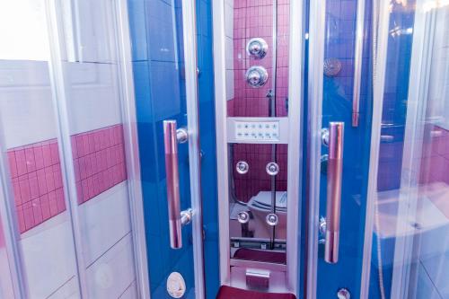 a bathroom with a shower with a toilet in it at Krikonis Hotel in Ioannina