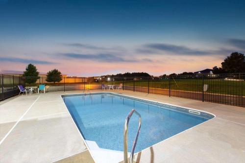 a swimming pool with a fence around it at La Quinta by Wyndham Blue Springs in Blue Springs