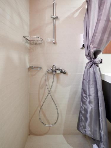 a shower with a shower curtain in a bathroom at Angie Luxury Beach Villas in Ayia Napa