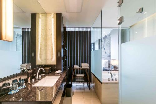 a bathroom with two sinks and a large window at CITIC Pacific Zhujiajiao Jin Jiang Hotel in Qingpu