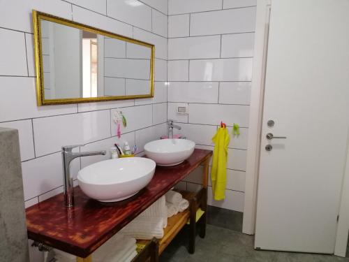 a bathroom with two sinks and a mirror at Villa Bougainvillea in Ashalim