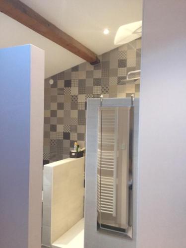 a bathroom with a sink and a mirror in a room at Entre Lyon et Beaujolais in Châtillon