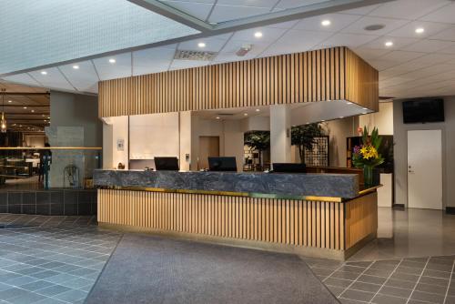 a lobby with a reception desk in a building at Quality Hotel Sarpsborg in Gralum