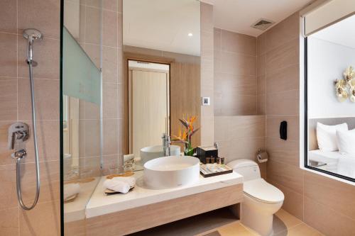 a bathroom with a sink and a toilet and a shower at DQua Hotel in Nha Trang