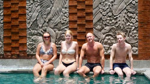 a group of people sitting in a swimming pool at Perissos Echo Beach in Canggu