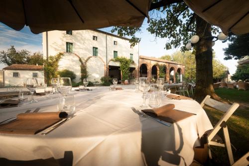 a table with glasses and napkins on it in front of a building at AGRITURISMO LA CAMPAGNOLA in Montegaldella