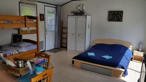 a bedroom with a bed and a bunk bed at Le Moulin à Rêves in Talmont