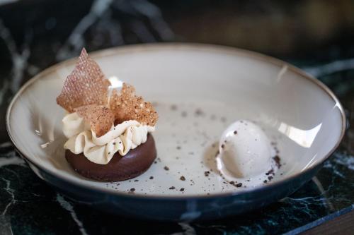 two desserts in a bowl with a scoop of ice cream at La Maison d'Estournel in Saint-Estèphe