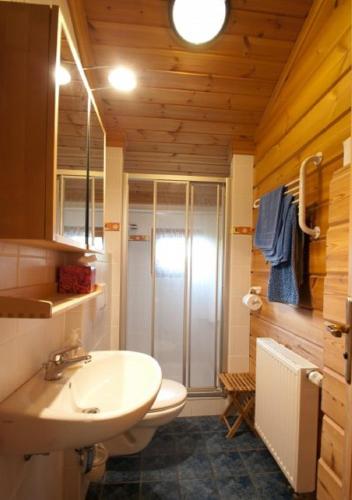 a bathroom with a white sink and a toilet at Ferienhof Pfeiffer in Buchen