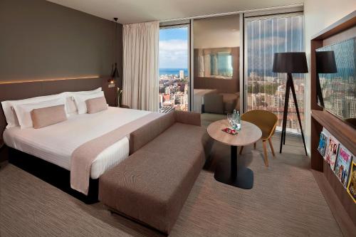 a hotel room with a large bed and a table at Melia Barcelona Sky 4* Sup in Barcelona