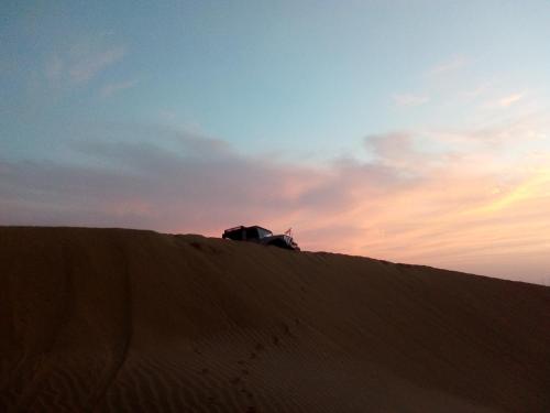 a truck sitting on top of a sand dune at Blue Eye Hostel in Jaisalmer