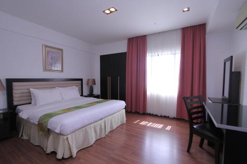 A bed or beds in a room at Likas Square - KK Apartment Suite