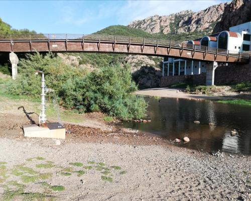 a train is crossing a bridge over a river at Апартаменты с великолепным видом на горы in Viddalba