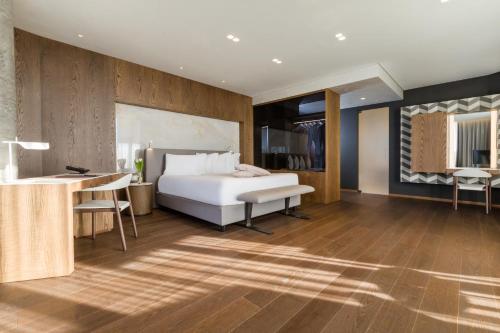 a hotel room with a bed and a desk and a desk at Maritim Hotel Plaza Tirana in Tirana